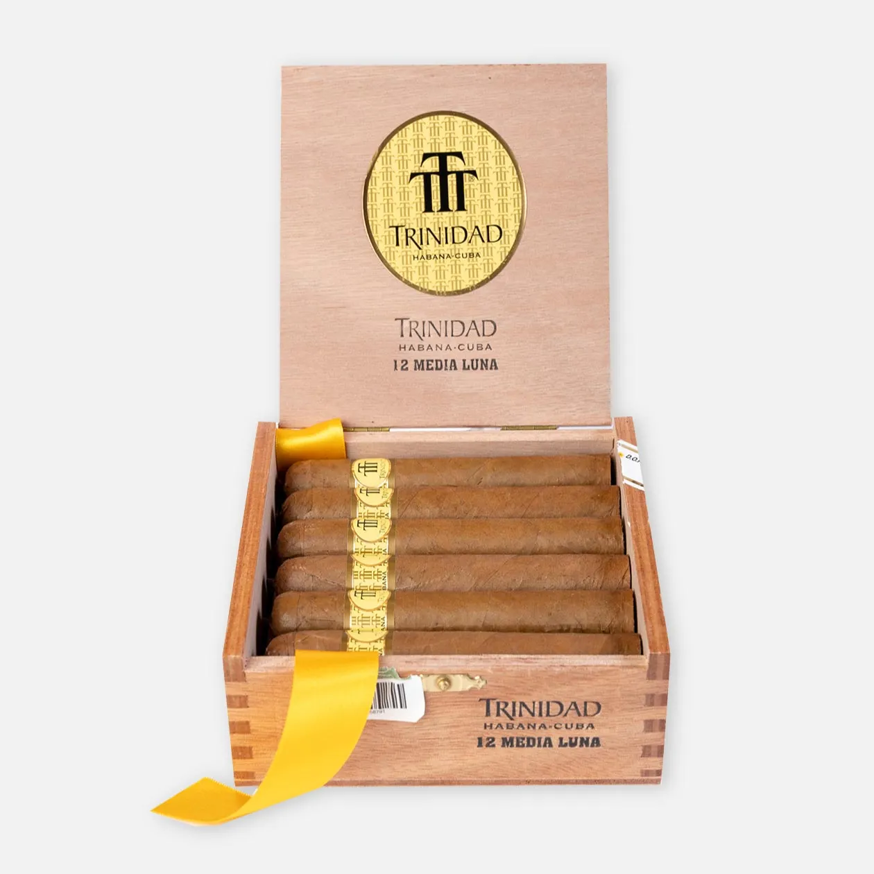 Trinidad Media Luna cigars in a wooden box with gold accents.